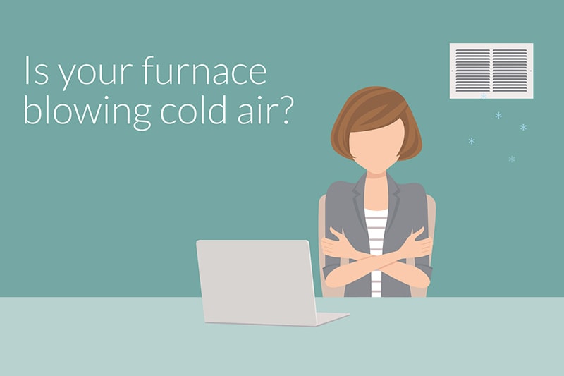 Why Is My Furnace Blowing Cold Air? Woman working at her table while cool air blows on her.